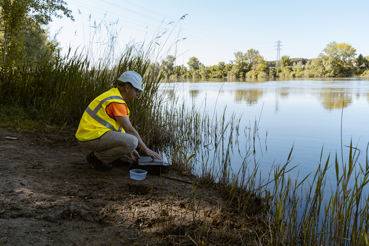 An environmental technician in a water quality control of a river.