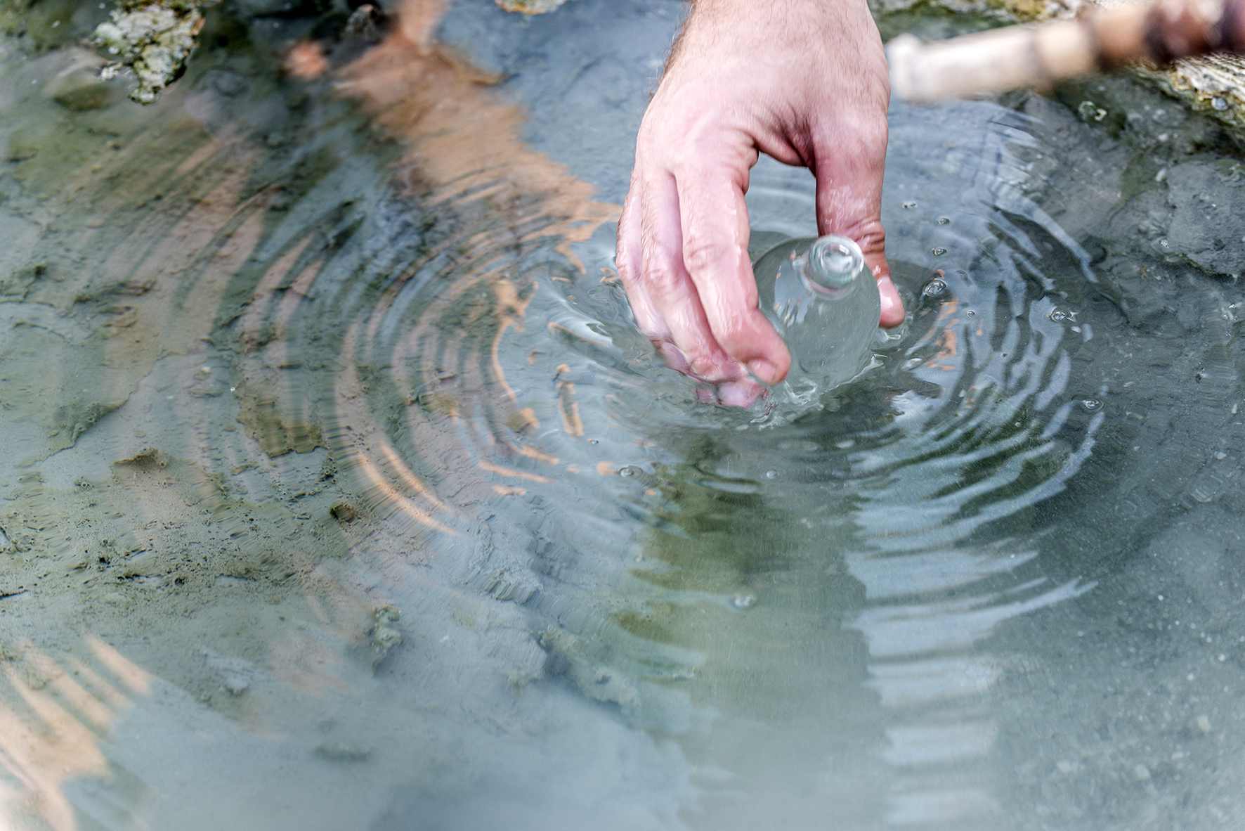 Person Collecting a Water Sample
