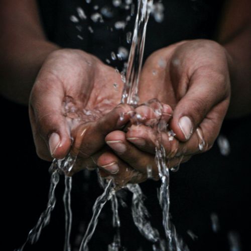 Water flowing through cupped hands