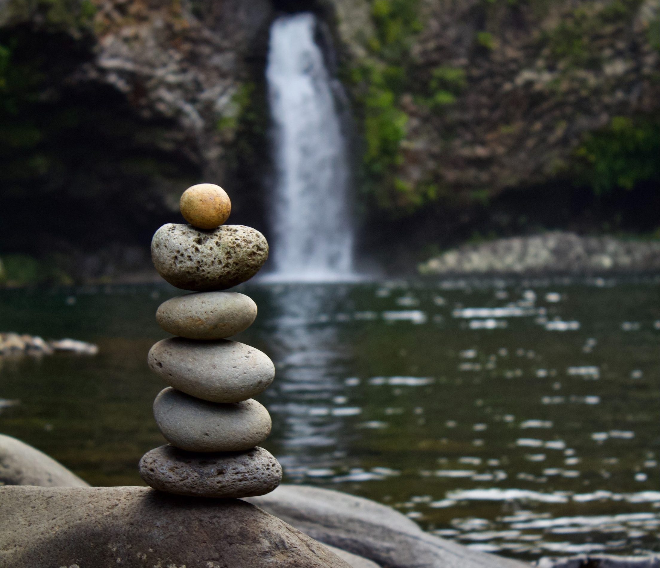 Stack of rocks by waterfall